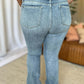 Woman wearing Judy Blue medium rise bootcut jeans showing back view with a flattering fit and classic design.