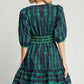 Back view of Umgee Ribbon Print Frill Contrast Velvet Trim Half Sleeve Dress with green bow design and flared skirt.