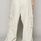 Back view of cream cargo pants with crochet patches, showcasing a relaxed fit and trendy style.