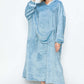 Woman modeling a cozy blue hooded midi lounge dress with pockets, perfect for chilly fall days.