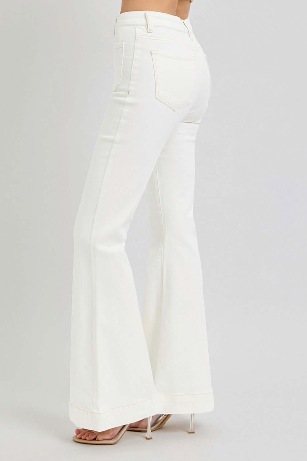 Stylish high-rise white flare jeans with front patch pockets, perfect for a trendy casual look. Comfortable denim fabric.