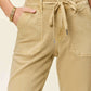 High waist jogger jeans with elasticized waistband and drawstring, shown in beige, combining style and comfort by Judy Blue Jeans.