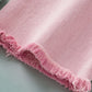 Close-up of pink raw hem detailing on petite button-fly jeans with no stretch, made of 98% cotton and 2% elastane.