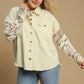 Stylish plus size woman wearing Umgee distressed detail raw hem button-up jacket with leopard print sleeves.