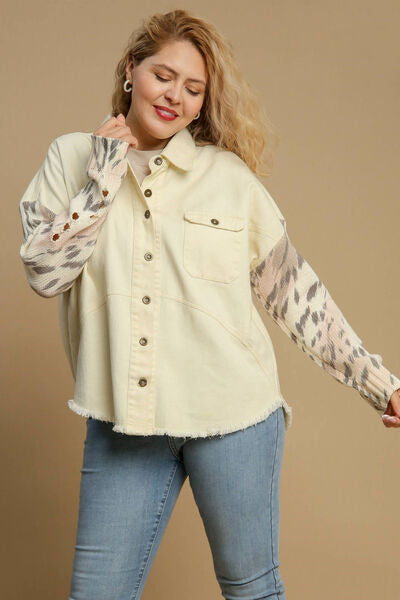 Stylish plus size woman wearing Umgee distressed detail raw hem button-up jacket with leopard print sleeves.