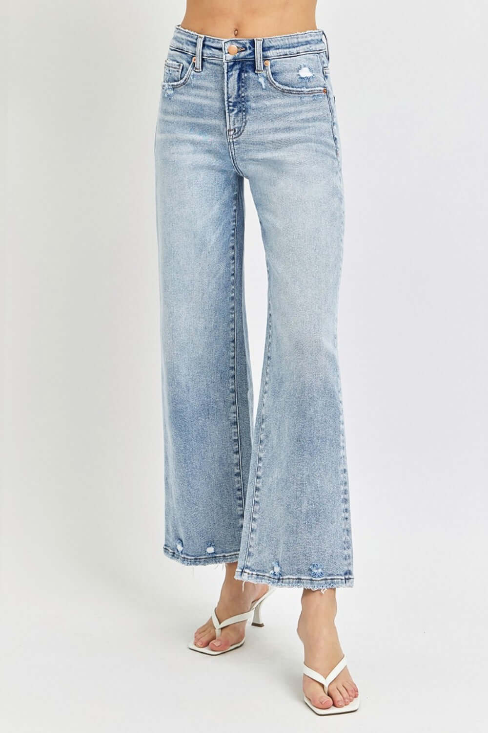 Wide leg high-rise crop jeans with tummy control feature, combining comfort and style, perfect for casual and dressy occasions.