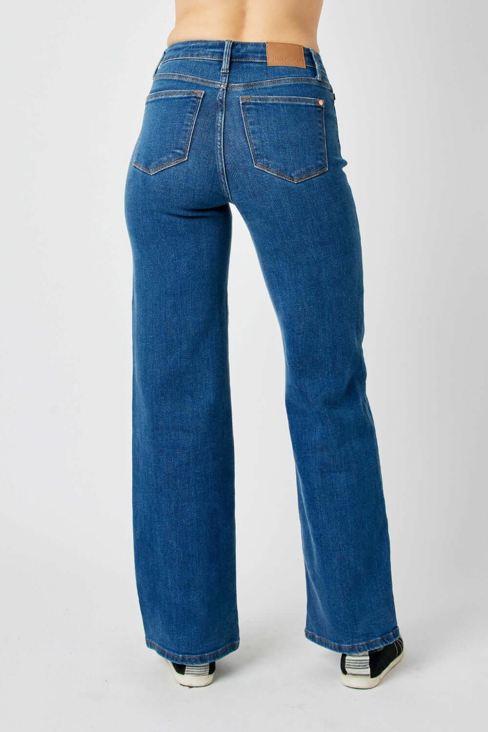 Judy Blue high rise straight jeans show back view, accentuating waist and elongating legs. Versatile fashion essential for any wardrobe.