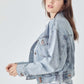 Woman wearing RISEN full size button down cropped denim jacket with casual chic style.