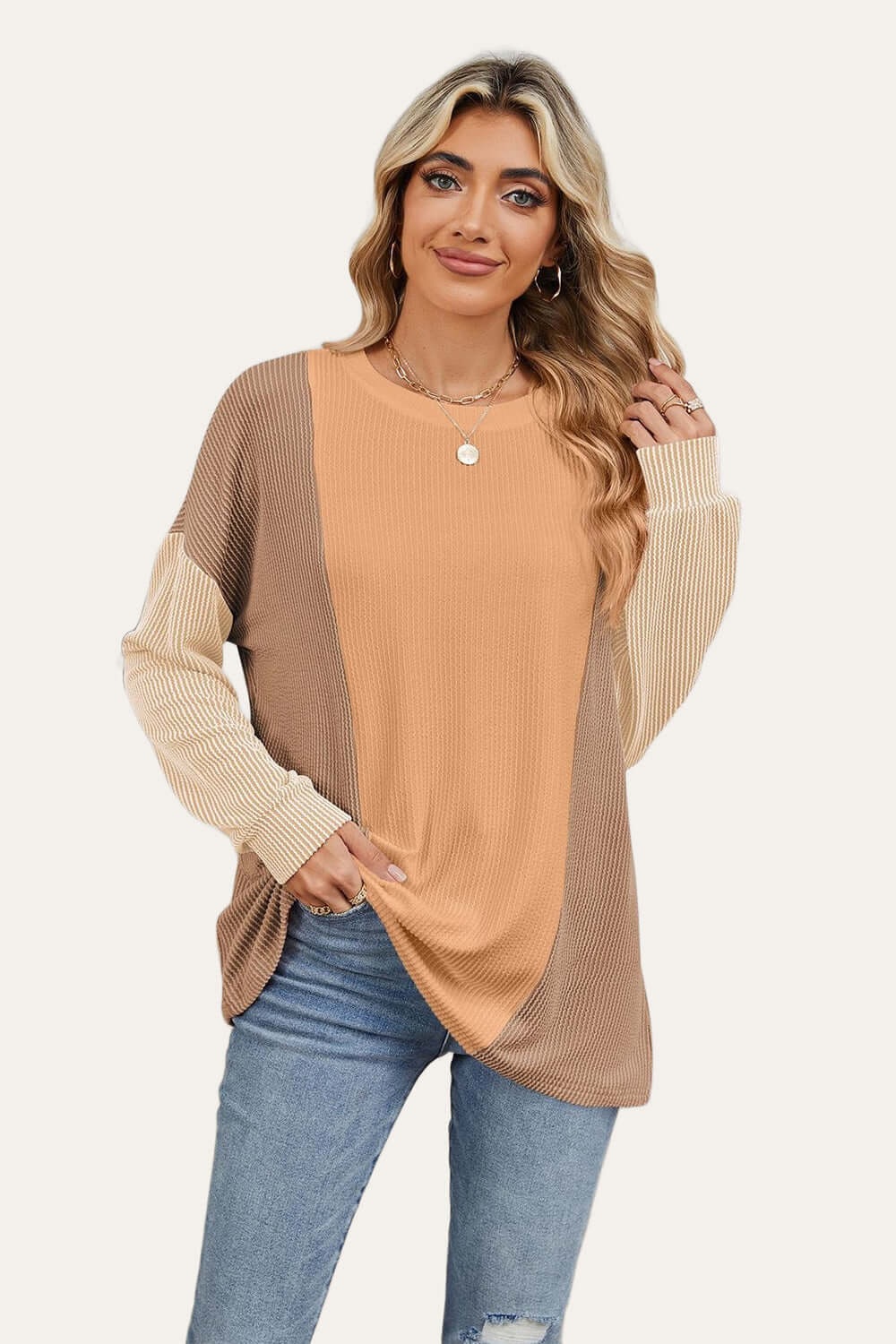 Woman wearing Double Take Texture Contrast Round Neck Long Sleeve T-Shirt in trendy color combo, perfect for stylish layering.