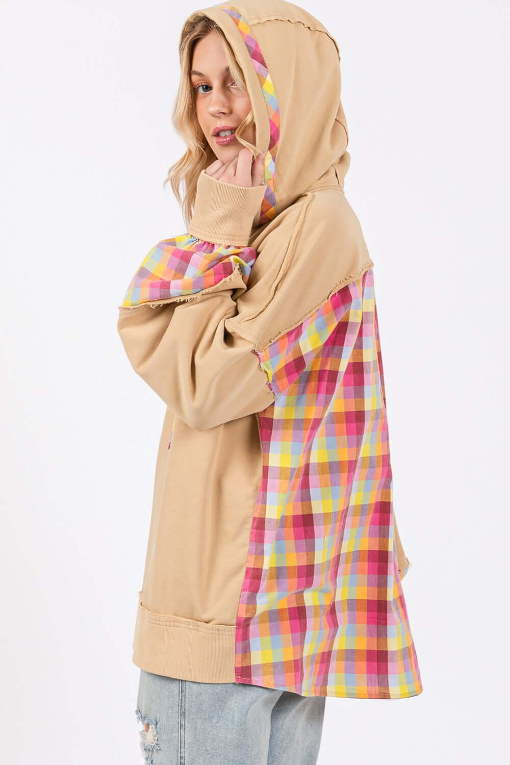 Woman in beige mineral wash hoodie with plaid print hood and back side, showing contrast multi-plaid design and relaxed fit.