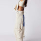 Ivory Bella Road Denim Overalls with Wide Straps and Pockets, Styled for Adventure and Fashion in a Trendy Look.