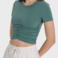 Millennia Ruched Active T-Shirt in dark green, featuring a stylish ruched design and short sleeves, perfect for active wear.