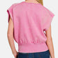 Woman wearing pink washed boat neck dolman sleeve top with bottom banded hem paired with jeans, showcasing back view