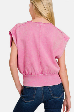 Woman wearing pink washed boat neck dolman sleeve top with bottom banded hem paired with jeans, showcasing back view