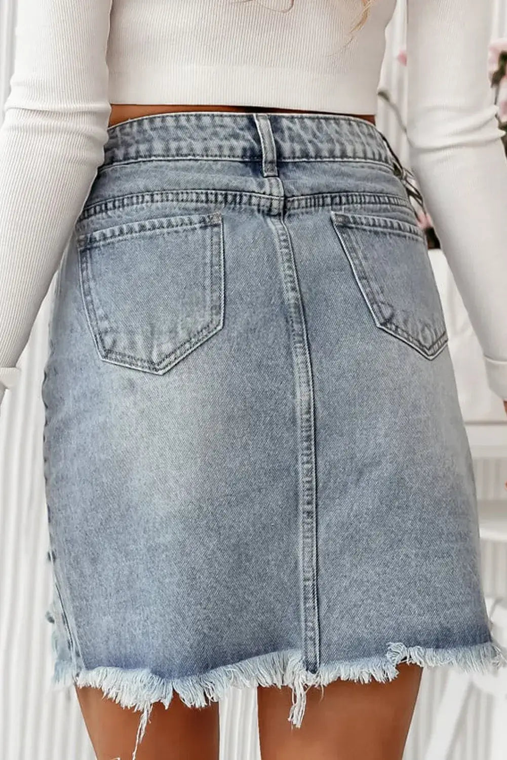 Bella Road Distressed Raw Hem Heart Mini Denim Skirt back view showing edgy style and playful raw hem design.