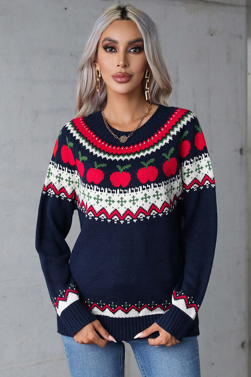 Model wearing angel wings sweater with apple graphic, round neck, and long sleeves, perfect for a quirky, whimsical style.