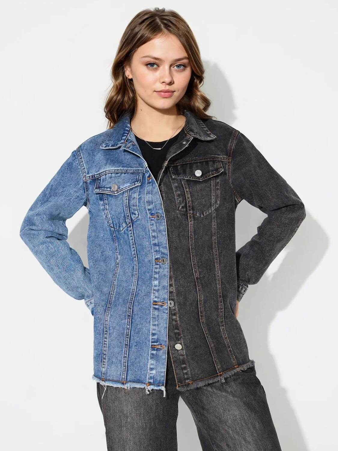 Woman wearing Bella Road Raw Hem Contrast Collared Neck Denim Top, showcasing a stylish blend of blue and black denim patches.