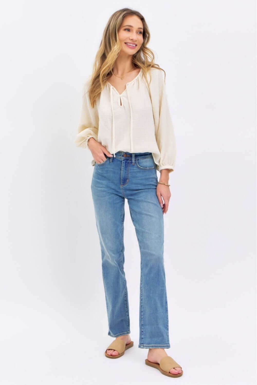 Woman wearing High Waist Straight Judy Blue Jeans with a white blouse, showcasing a versatile and on-trend casual outfit.