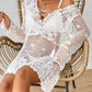 Woman wearing a Cutout Tied V-Neck Long Sleeve Cover Up in white crochet design, sitting on a wooden chair