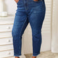 Model wearing Judy Blue High Waist Released Hem Slit Jeans in deep indigo wash with a flattering fit and slim silhouette.