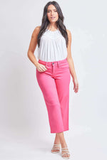 Woman modeling YMI Jeans Mid-Rise Hyperstretch Cropped Straight Pants in pink with white sleeveless top.