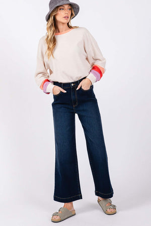 Model wearing High Waist Wide Leg Jeans with front and back pockets, paired with a casual long-sleeve top and sandals.