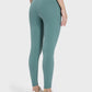 Millennia Pocketed High Waist Active Leggings in green, showcasing a stylish and comfortable fit from the back.