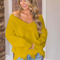 Woman wearing Bella Road frayed hem sweater with dropped shoulders, adding playful style and comfort to her outfit.