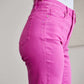 Woman wearing pink high waist RFM jeans with tummy control and raw hem, showcased with a close-up side view.