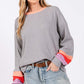 Woman wearing Color Block Waffle Knit T-Shirt with seam color block raglan sleeves, contrast crew neckline, and relaxed fit, paired with jeans.