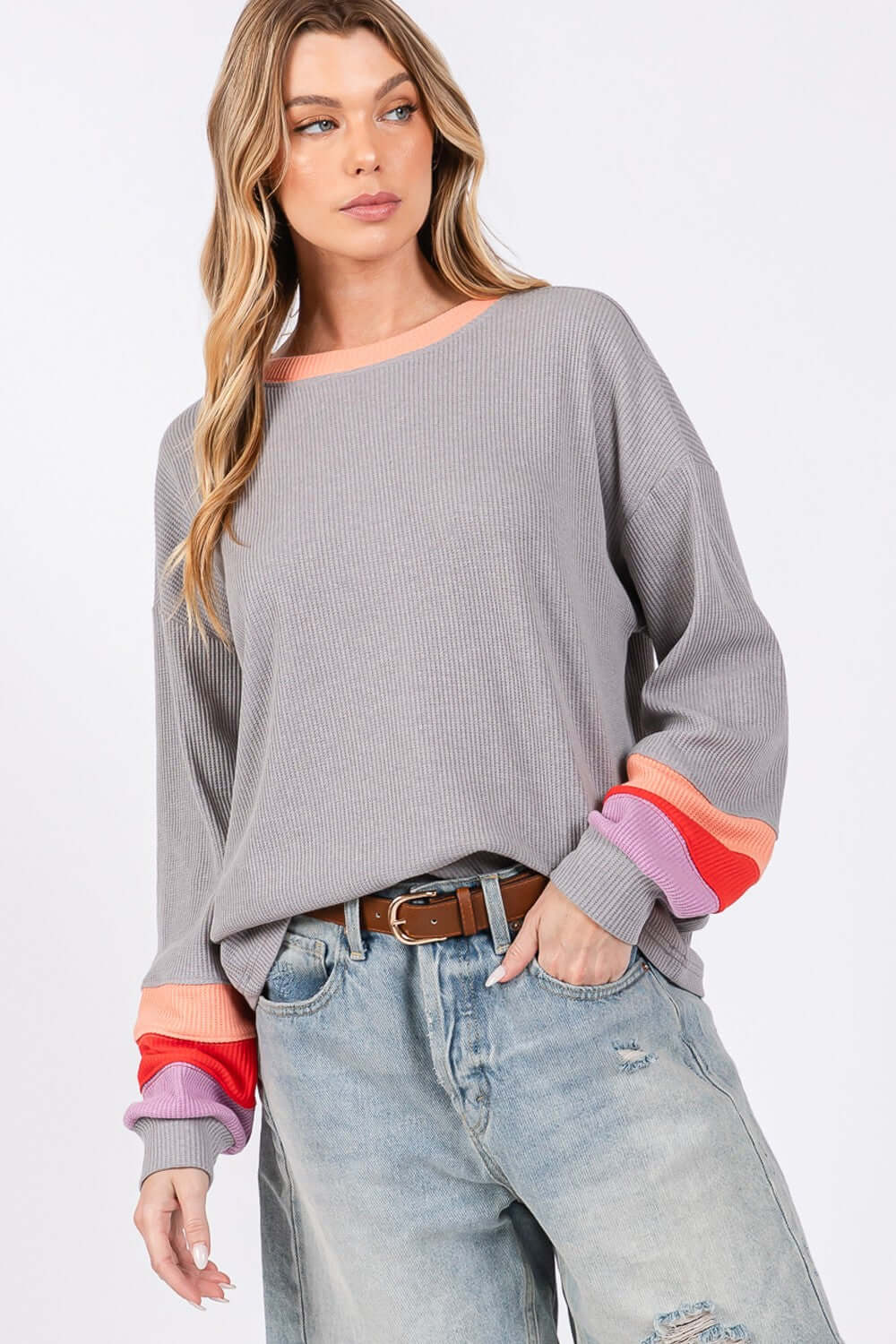 Woman wearing Color Block Waffle Knit T-Shirt with seam color block raglan sleeves, contrast crew neckline, and relaxed fit, paired with jeans.