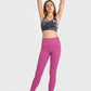 Model showcasing Millennia High Waist Ankle-Length Yoga Leggings in vibrant pink, pair with a stylish sports bra and wrist weights.