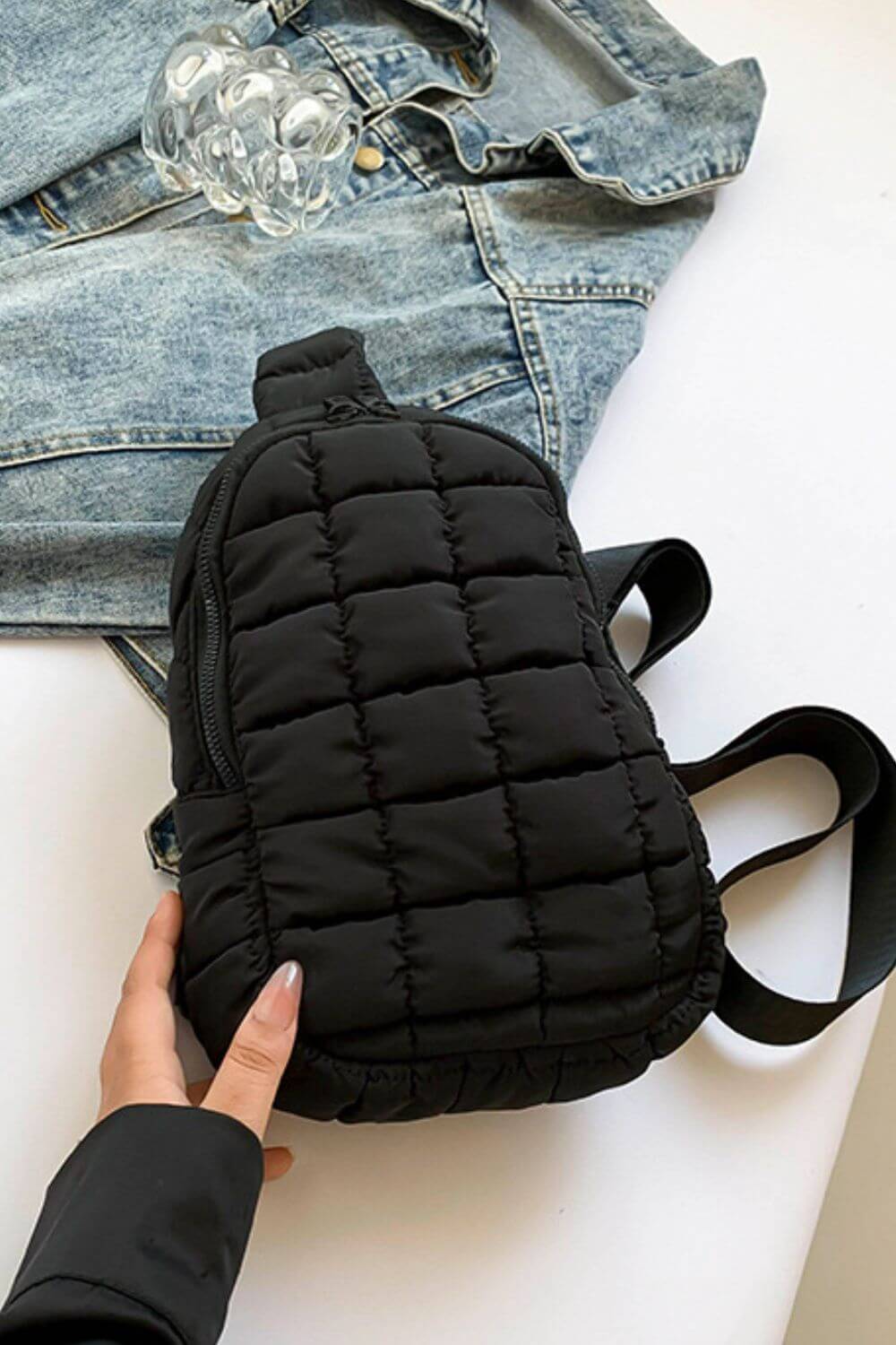 Black Bella Road Quilted Nylon Crossbody Bag styled with denim, showcasing trendy and durable design for any adventure.