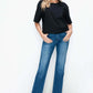 Model showcasing bytos Cat's Whiskers High Rise Straight Jeans paired with a black top and stylish heels.