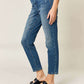 Woman wearing Tummy Control High Waist Slim Jeans by Judy Blue, showcasing a flattering silhouette and slimming effect.