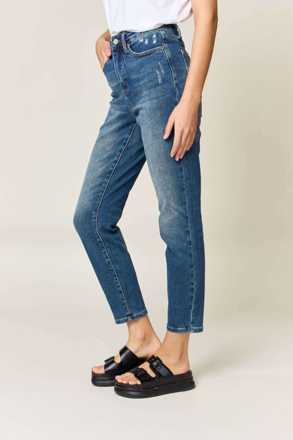 Woman wearing Tummy Control High Waist Slim Jeans by Judy Blue, showcasing a flattering silhouette and slimming effect.