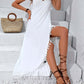 Woman wearing white backless tassel surplice spaghetti strap cover up dress with a woven bag and strappy sandals.