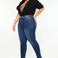 Woman wearing Kancan full-size high-rise ankle skinny jeans in dark wash with a double waistband and stylish release hem.