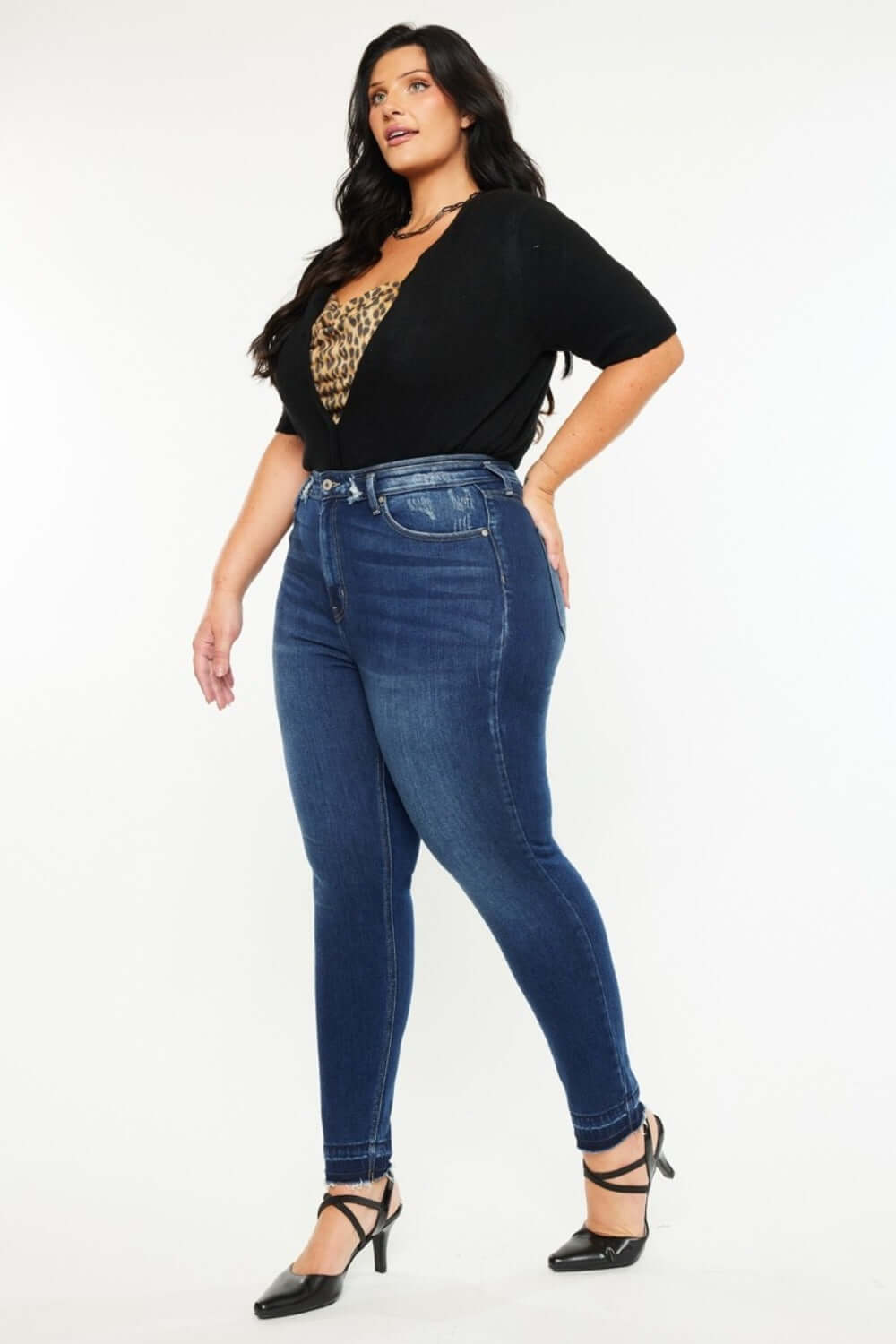 Woman wearing Kancan full-size high-rise ankle skinny jeans in dark wash with a double waistband and stylish release hem.