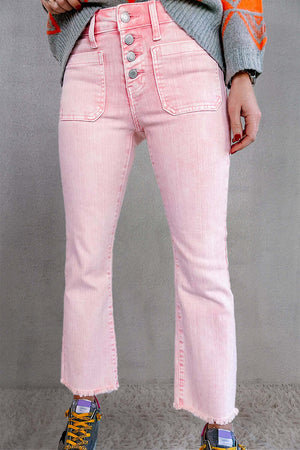 Woman wearing pink raw hem button-fly jeans with pockets, perfect for petites.