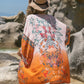 Stylish woman wearing Bella Road printed open front cover-up by the beach, features bright colors and floral patterns.