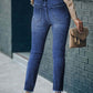 Woman wearing high waist raw hem skinny jeans with pockets, casual outdoor style with slightly stretchy cotton-polyester blend.