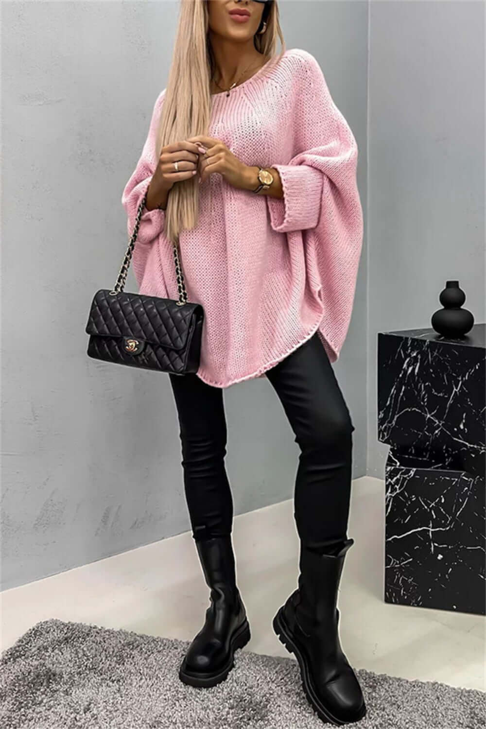 "Bella Road pink batwing sleeve sweater, styled with black leather pants and a chic handbag"