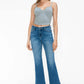 Model showcasing bytos Cat's Whiskers Mid Rise Ankle Jeans with a trendy cropped top and stylish sneakers.