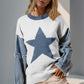 Woman wearing Double Take Full Size Star Pattern Raw Edge Long Sleeve Sweater, featuring unique raw hem and star design.