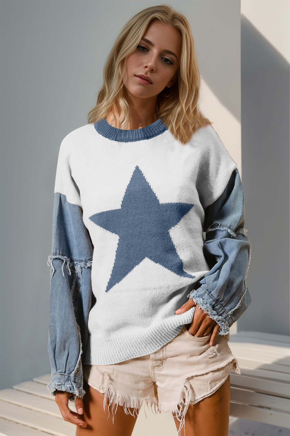 Woman wearing Double Take Full Size Star Pattern Raw Edge Long Sleeve Sweater, featuring unique raw hem and star design.