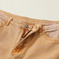 Close-up of Distressed Raw Hem Jeans with Pockets showcasing the top button and zipper detail in light beige color.