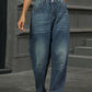 Woman wearing half elastic waist straight leg jeans with a white crop top for a stylish yet comfortable look