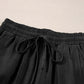 Close-up of Bella Road Drawstring Wide Leg Jeans in black, showcasing the trendy drawstring waist and soft fabric.