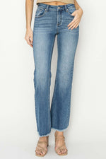 Mid-rise frayed hem bootcut jeans by Risen Jeans, showcasing trendy, edgy style, paired with sandals for a boho-chic look.